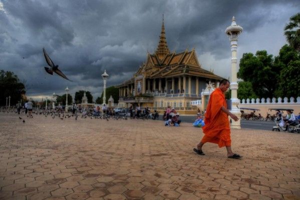 Front image of the First TYPO3 Conference in Asia depicting a monk walking past the Royal Palace in Phnom Penh.